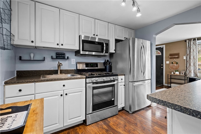 kitchen featuring white cabinets, sink, and appliances with stainless steel finishes