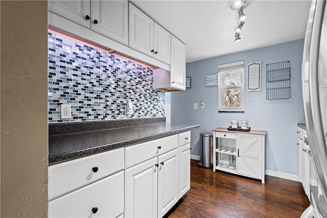 kitchen with white cabinetry, decorative backsplash, and dark hardwood / wood-style floors