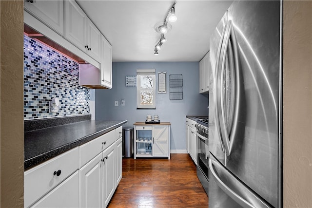 kitchen with appliances with stainless steel finishes, decorative backsplash, dark hardwood / wood-style floors, and white cabinets