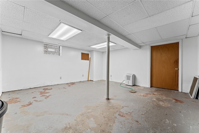 basement featuring a paneled ceiling