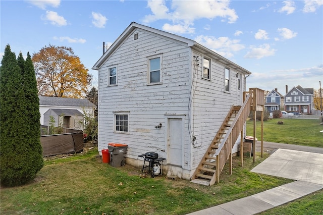 rear view of house featuring a lawn