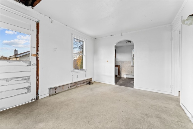 carpeted empty room with a baseboard radiator