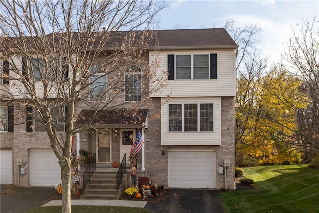 view of front of property featuring a garage and a front yard