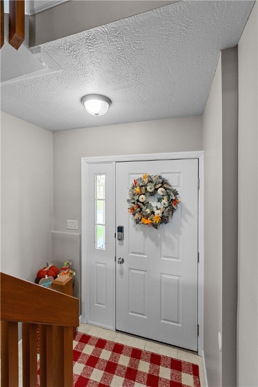 foyer with a textured ceiling