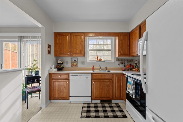 kitchen featuring white appliances and sink