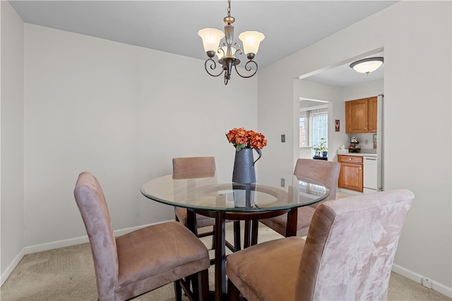 dining room with light carpet and a notable chandelier