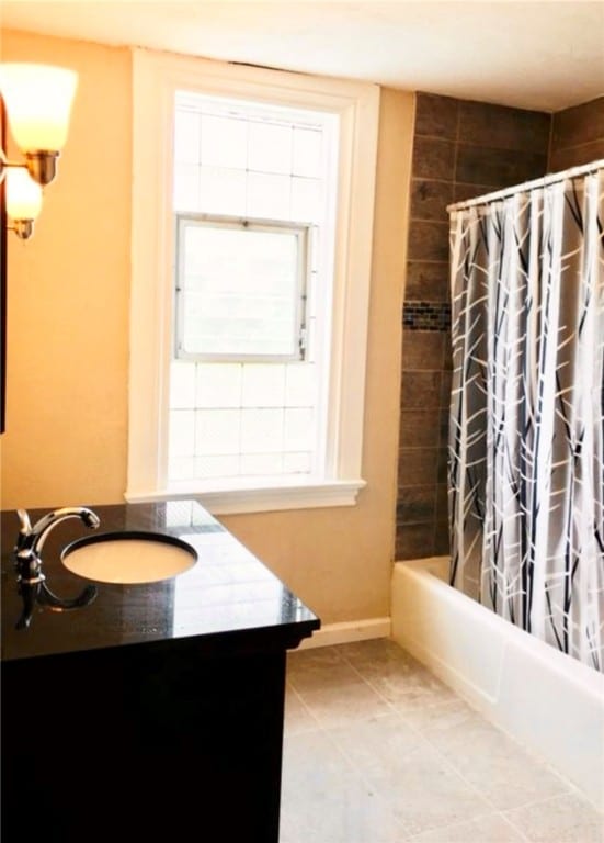 bathroom with shower / bath combo, sink, and tile patterned floors