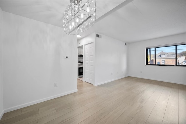 interior space with light hardwood / wood-style floors and a notable chandelier