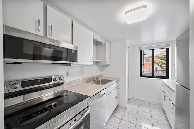 kitchen featuring appliances with stainless steel finishes, sink, and white cabinets