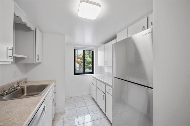 kitchen featuring stainless steel appliances, white cabinets, sink, and light tile patterned floors