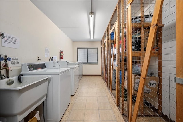 laundry area featuring washer and clothes dryer and sink