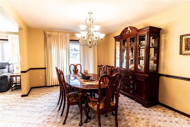 dining room with light carpet and a chandelier