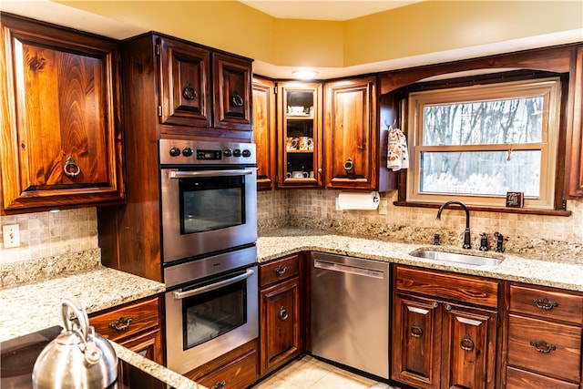 kitchen with stainless steel appliances, sink, and tasteful backsplash