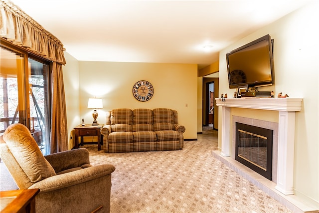 living room featuring a tile fireplace and light carpet