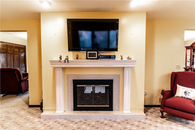 living room with a tile fireplace and light tile patterned flooring