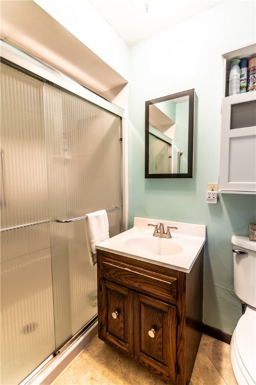 bathroom featuring walk in shower, tile patterned flooring, vanity, and toilet