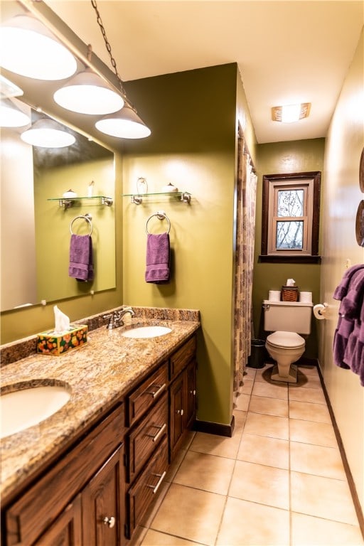 bathroom featuring tile patterned flooring, vanity, and toilet