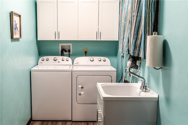 laundry area with cabinets, hardwood / wood-style floors, sink, and independent washer and dryer