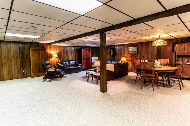 interior space featuring beamed ceiling and wooden walls