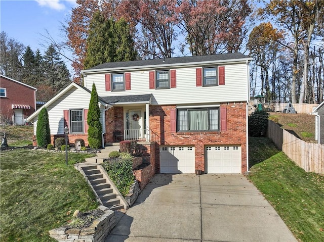 view of front of property featuring a front yard and a garage