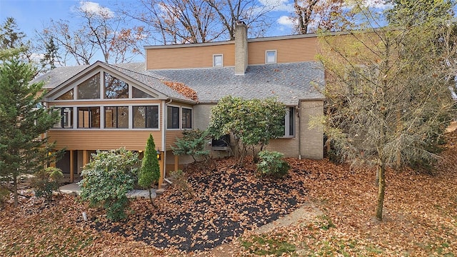 back of property with a sunroom