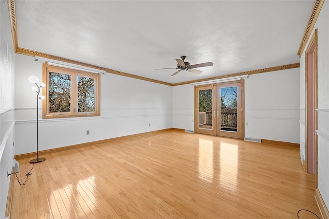 interior space with ornamental molding, ceiling fan, french doors, and light hardwood / wood-style floors