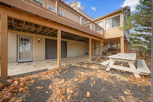 back of house featuring a patio area and a deck