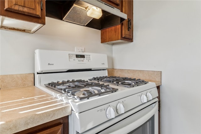 kitchen with extractor fan and white gas range oven