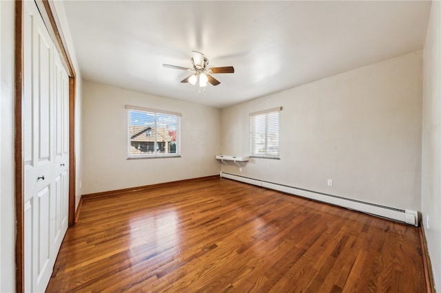 unfurnished bedroom with hardwood / wood-style floors, ceiling fan, and a baseboard radiator