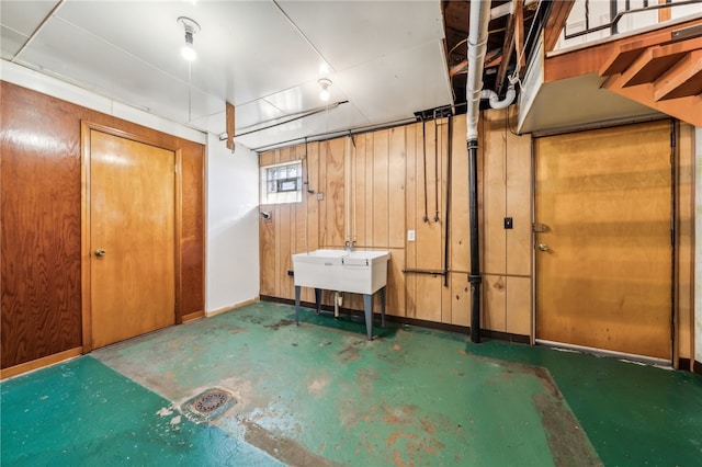 basement featuring wooden walls