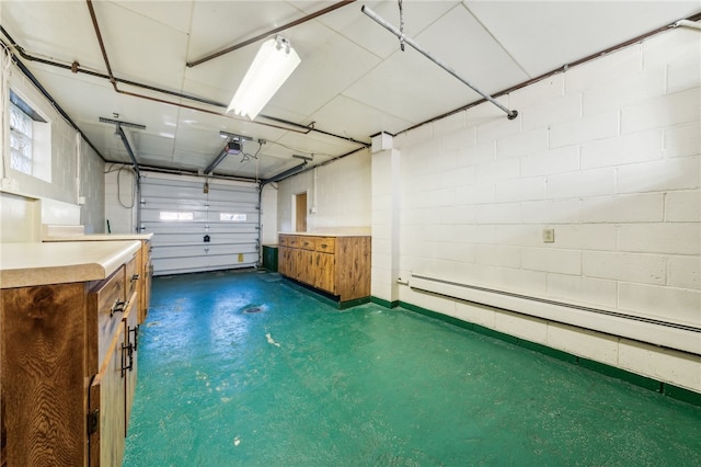 garage featuring a baseboard radiator and a garage door opener