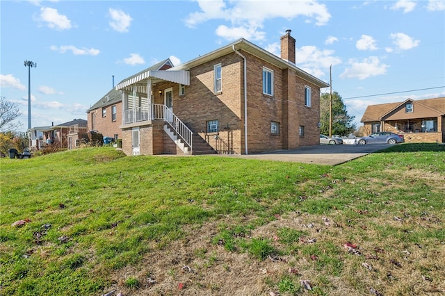 rear view of house with a lawn