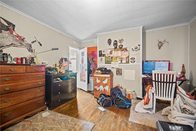 bedroom with dark hardwood / wood-style flooring and ornamental molding