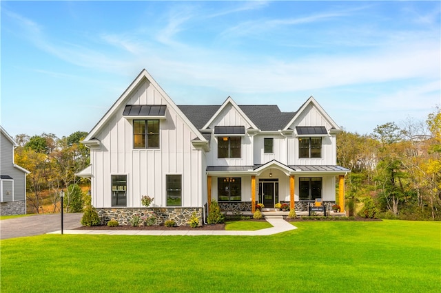 modern inspired farmhouse featuring a porch and a front lawn