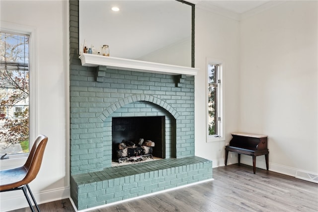 interior details with ornamental molding, a fireplace, and hardwood / wood-style flooring