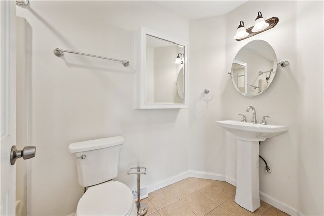 bathroom featuring tile patterned flooring and toilet