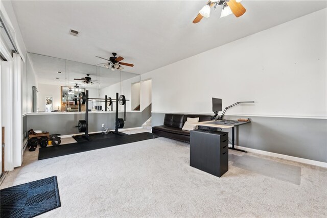 carpeted living room with ceiling fan