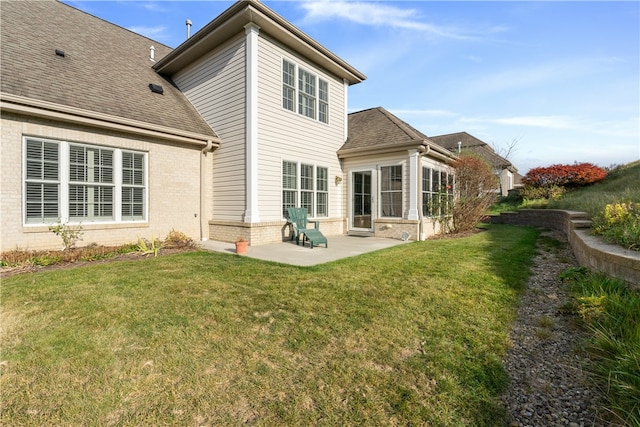 rear view of property featuring a yard and a patio