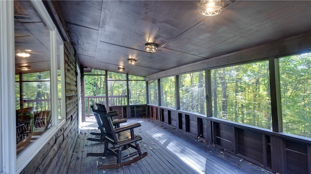 unfurnished sunroom with vaulted ceiling