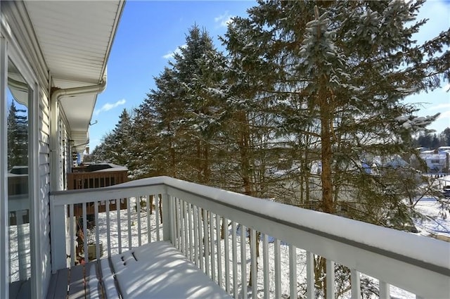 view of snow covered back of property