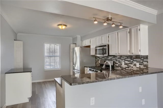 kitchen with stainless steel appliances, white cabinetry, dark wood-type flooring, and kitchen peninsula