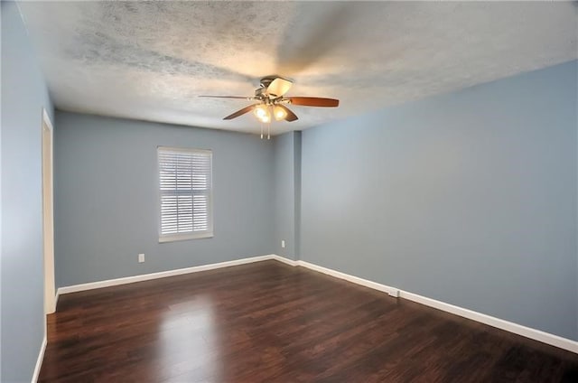 spare room with a textured ceiling, dark hardwood / wood-style floors, and ceiling fan