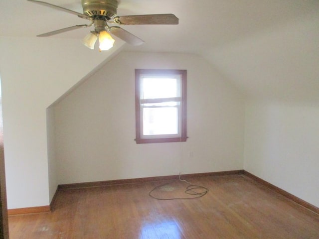 additional living space featuring lofted ceiling, hardwood / wood-style flooring, and ceiling fan