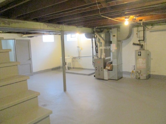 basement featuring heating unit and gas water heater