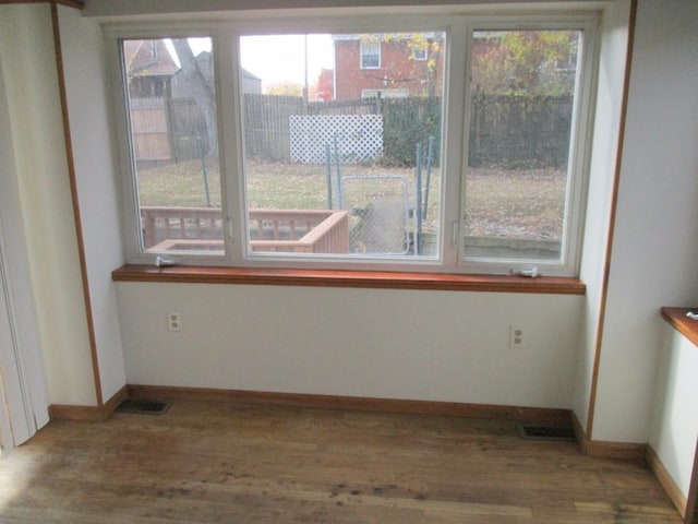 interior space with hardwood / wood-style flooring and a healthy amount of sunlight