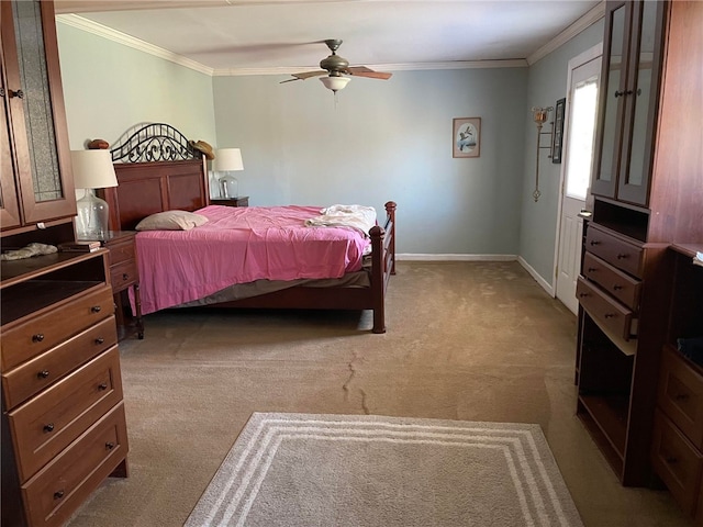 bedroom featuring ceiling fan, light carpet, and crown molding