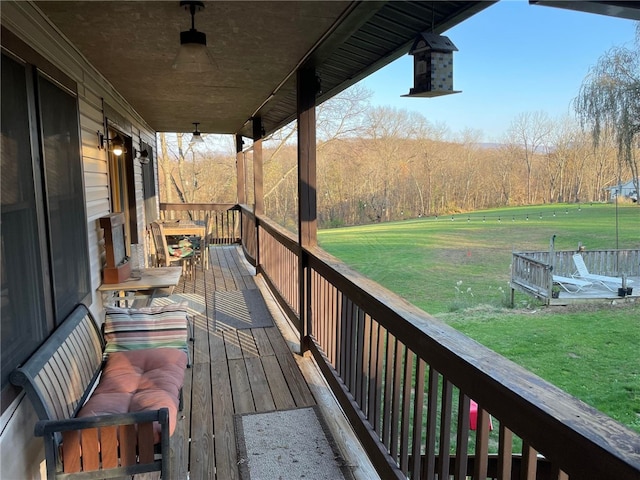 wooden deck with a lawn