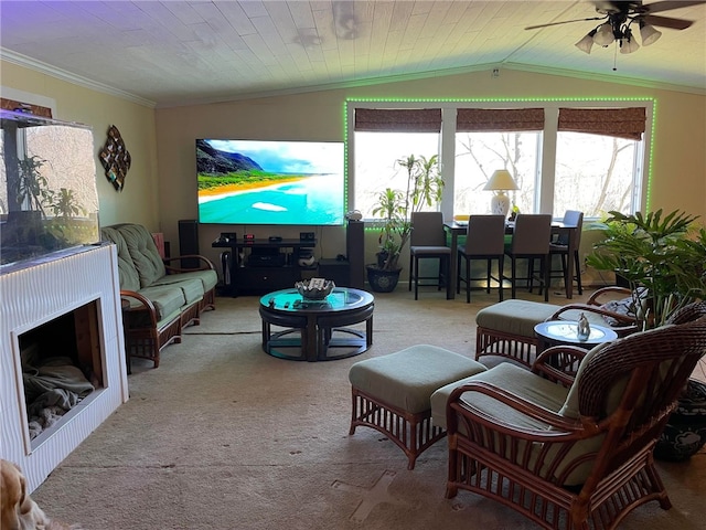 carpeted living room featuring ceiling fan, vaulted ceiling, and ornamental molding