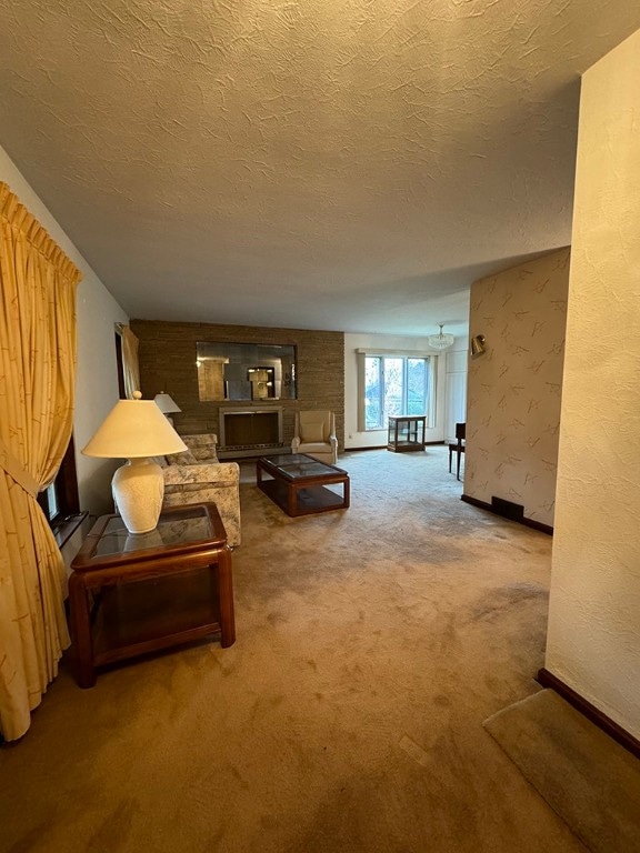 carpeted living room featuring a textured ceiling