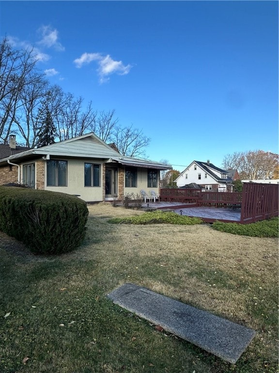 back of house with a patio and a yard